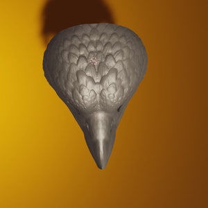 May include: A gray ceramic bird sculpture with a detailed textured surface. The bird's head is tilted down and its beak is pointed.