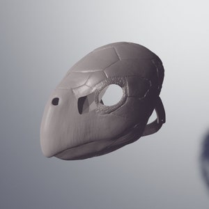 May include: A gray 3D printed turtle head mask with a textured shell and eye holes.