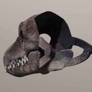 May include: A detailed, textured rendering of a dinosaur skull, featuring a prominent jawline with sharp, white teeth. The skull has a rough, gray surface and a dark, shadowed area at the top, set against a neutral background. The design is reminiscent of prehistoric creatures.