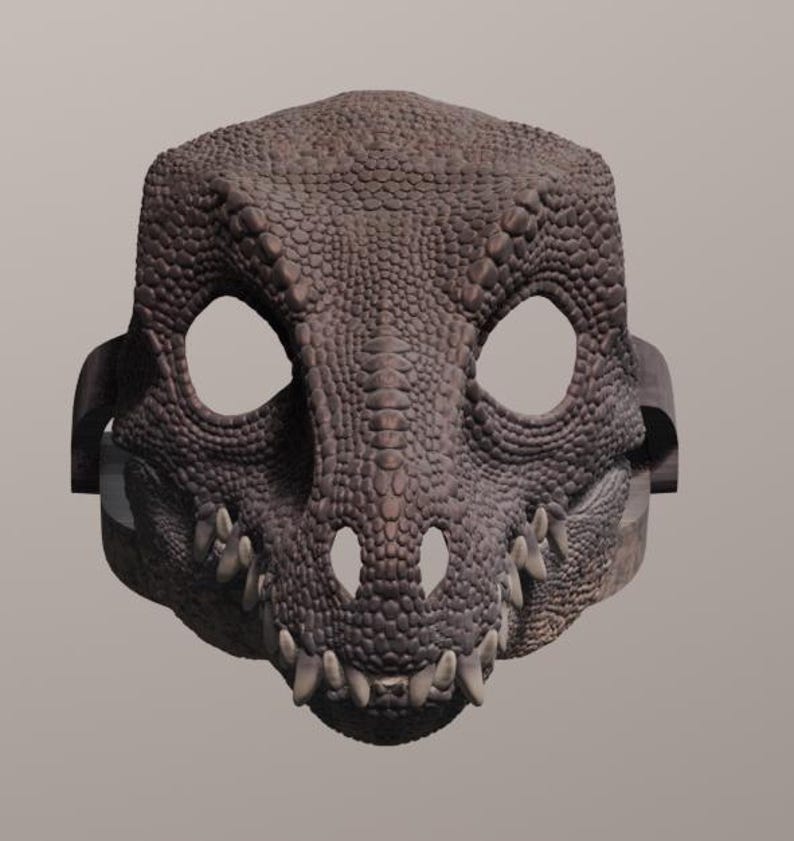 May include: A detailed, brown dragon mask with large eye openings and sharp teeth. The mask has a textured, scaly appearance and is designed to be worn. The mask is a costume accessory.