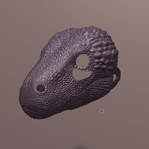 May include: A purple 3D printed dinosaur mask with a textured surface and eye holes.