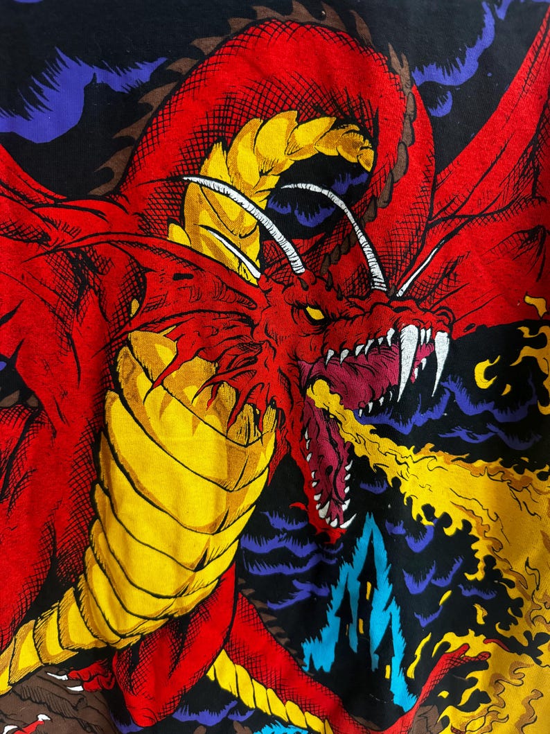 May include: A red dragon with yellow scales and white horns breathes fire against a black background with purple and blue clouds.