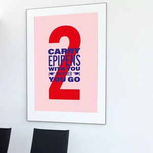 May include: A framed poster with a pink background and a large red number "2" in the center. The text "Carry Epipens With You Wherever You Go" is written in blue letters inside the number.
