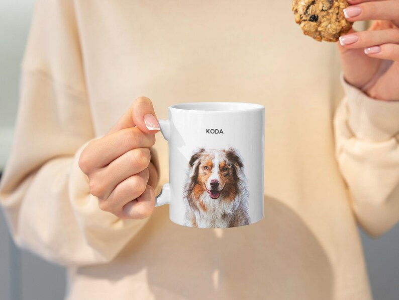May include: White ceramic mug with a photo of a brown and white Australian Shepherd dog with the name "KODA" printed on the mug.