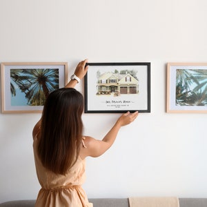 woman hanging a custom home portrait frame