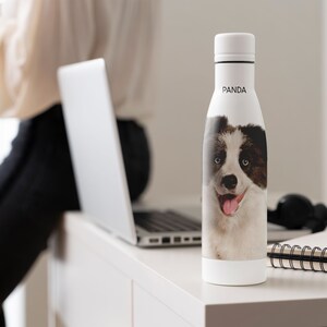 May include: White water bottle with a black and white dog image and the word "PANDA" printed on the side.