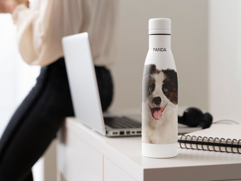 May include: White water bottle with a black and white dog image and the word "PANDA" printed on the side.
