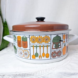 May include: A white enamel stockpot with a brown lid and two side handles. The exterior features a grid pattern with orange and green illustrations of kitchen utensils, flowers, salt and pepper shakers, a fondue pot, and various drinkware.