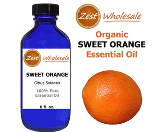 May include: A blue glass bottle with a black cap, labeled "Zest Wholesale Organic Sweet Orange Essential Oil". The bottle contains 8 fluid ounces of oil. The label also includes the botanical name "Citrus Sinensis" and states that the oil is 100% pure. A whole orange is pictured next to the bottle.