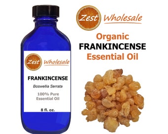 May include: A blue glass bottle with a white label that reads "Zest Wholesale Organic FRANKINCENSE Essential Oil" and "Boswellia Serrata 100% Pure Essential Oil 8 fl. oz.". The bottle is next to a pile of brown frankincense resin.