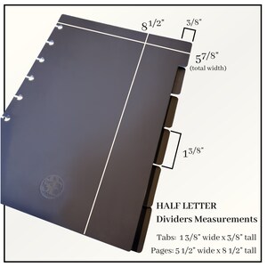 May include: A dark grey half-letter size planner with a black divider set. The dividers have tabs that are 1 3/8 inches wide and 3/8 inches tall. The planner is 8 1/2 inches tall and 5 1/2 inches wide.