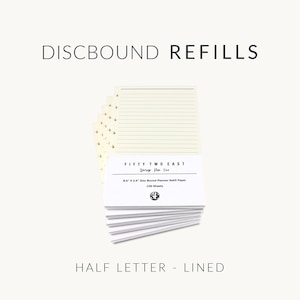 May include: A stack of cream-colored lined discbound planner refill paper measuring 8.5 inches by 5.5 inches. The packaging label reads FIFTY TWO EAST, Design For Life, 8.5" X 5.5" Disc Bound Planner Refill Paper, 100 Sheets. The text DISCBOUND REFILLS and HALF LETTER - LINED appears above and below the paper.