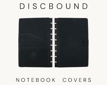 May include: A pair of black discbound notebook covers in half letter size. The left cover features an interior pocket with a diagonal opening, while the right cover includes a small side tab. The text DISCBOUND NOTEBOOK COVERS Half Letter is visible.