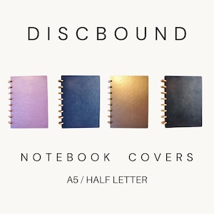May include: Four discbound notebook covers in lavender, navy blue, metallic gold, and black. The text DISCBOUND NOTEBOOK COVERS A5 / HALF LETTER is displayed. Each cover features a vertical row of gold-colored discs along the left edge for binding.