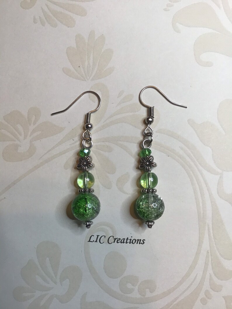 Silver dangle earring with green beads