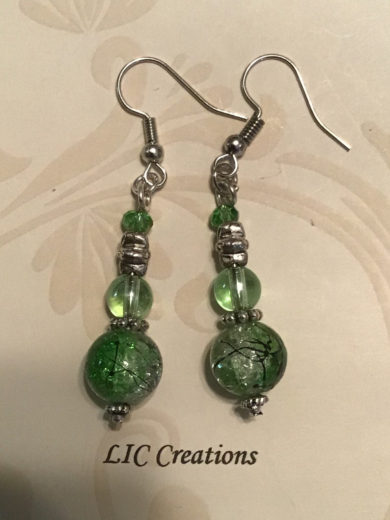 Silver dangle earring with green beads