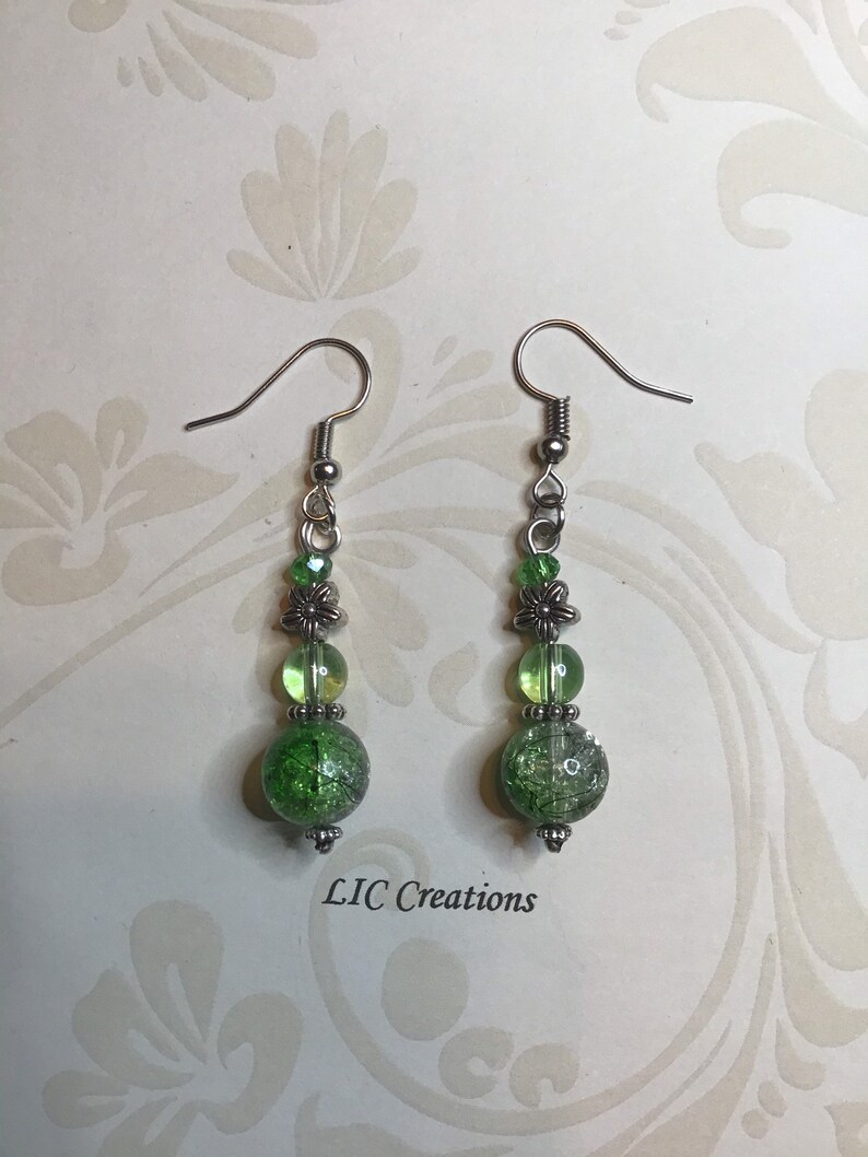Silver dangle earring with green beads
