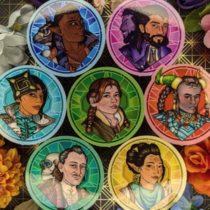 May include: Set of seven round stickers featuring colourful stained glass designs with portraits of different characters. Each sticker has a different colour scheme and features a unique character with different hairstyles, clothing, and accessories.