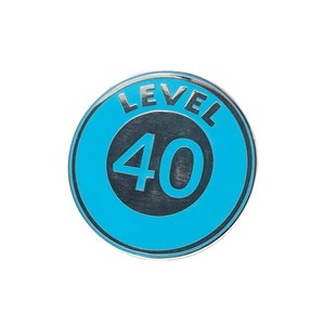 May include: A blue and silver circular pin with the text "LEVEL 40" in a white circle.