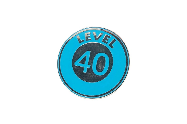 May include: A blue and silver circular pin with the text "LEVEL 40" in a white circle.