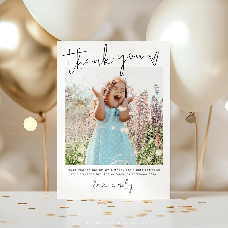 May include: A white thank you card with a photo of a girl in a blue dress, arms raised, laughing. Text reads "thank you" and "thank you for making my birthday party unforgettable! Your presence brought so much joy and happiness. love, emily."