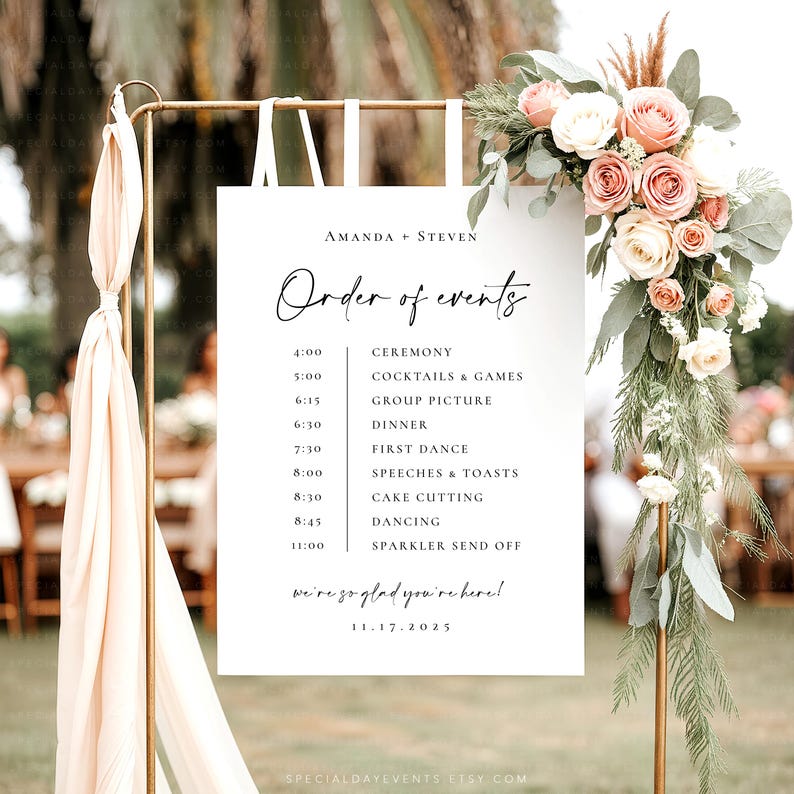 May include: A wedding event sign with the names "AMANDA + STEVEN" and the words "Order of events" in elegant script. The sign lists the schedule, including the ceremony, dinner, and dancing. The sign is decorated with flowers and ribbons.