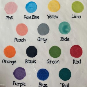 May include: A color chart featuring fourteen circular paint swatches on a white background. Each swatch is labeled with black text: Pink, Pale Blue, Yellow, Lime, Peach, Grey, Jade, Orange, Black, Green, Red, Purple, Blue, and Teal.