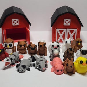 May include: A collection of miniature farm animal figurines, including a pig, cow, sheep, and chicken, along with two red barns with black roofs. The figurines are in various colors and poses, creating a charming farm scene.