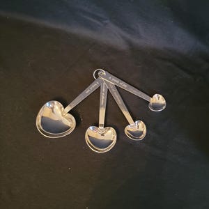 Stainless Steel Heart Measuring Spoons 4 Piece Set Embossed Handles, Measurement Sayins on each 1 Tablespoon - 1/4 Teaspoon. NIB