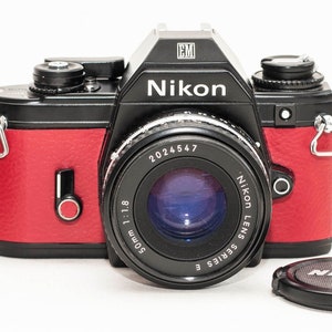 35 mm film camera Nikon EM with 50 mm f/1.8 NIKKOR lens.