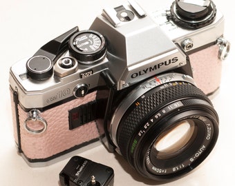 Olympus OM 10 with ZUIKO 50 mm f/1.8 lens and manual adapter - EXCELLENT. Light pink - metalic - new skin re-covered.