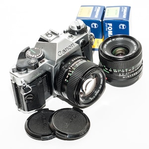 Canon AE -1 Program 35 mm film camera with 50 mm f/1.4 and 28 mm f/2.8 canon fd lenses - EXCELLENT.