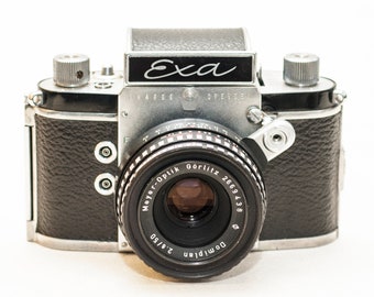 Exa Version 6 (1961) w/SLR prism finder; with Waist level finder Modular system and 50 mm f/2.8 DOMIPLAN lens.