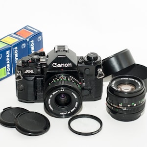 Canon A-1 film camera with 2 lenses 50 mm f/1.8 and 28 mm f/2.8 Three FOMAPAN b&w films 100/200/400iso 36 frames - EXCELLENT.