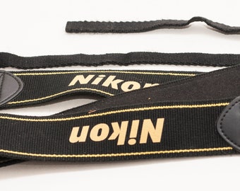 Camera strap with NIKON logo.