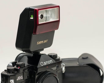 Vintage Canon hot shoe sppedlite 244T with case.