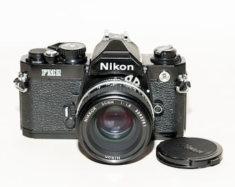 Nikon FM2 film camera with Nikon lens 50 mm f/1.8 and two FOMAPAN b&w films 100/200iso.