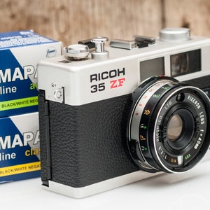 Ricoh 35 ZF film camera with two FOMAPAN b&w film rolls.