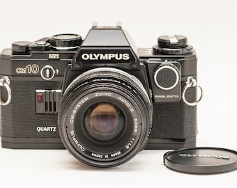 Olympus OM 10 - QUARTZ - with zuiko 50 mm f 1.8 lens and manual adapter.