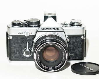 Olympus OM 2 MD with 50 mm f/1.8 lens - silver nose. Hot shoe 2 flash fitting included - EXCELLENT.