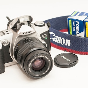 Canon EOS 500N with 35-80 mm lens f4-5.6 III original strap and two FOMAPAN B&W films.