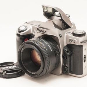 Nikon f65 film camera with 50 mm f/1.8 D lens.