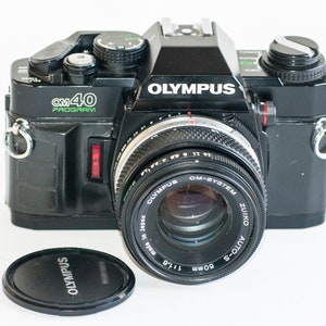 Vintage 35mm film camera Olympus OM 40 program with 50 mm f1.8 zuiko lens.