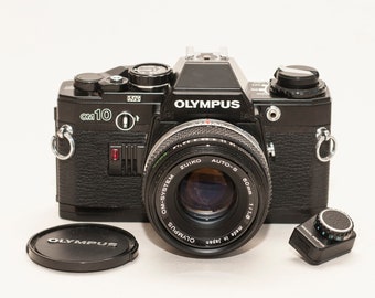 Olympus OM 10 - BLACK - with zuiko 50 mm f 1.8 lens and manual adapter. EXCELLENT.