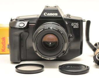 35 mm film camera Canon EOS 650 with Canon EF lens 50 mm f/1.8 and two colour films 200 ISO 24 frames .