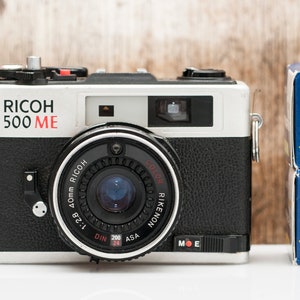 Ricoh 500 ME film camera with two FOMAPAN b&w film rolls.