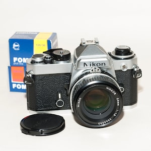 Nikon FE film camera with NIKKOR lens 50 mm f/1.8  and 2 FOMAPAN B&W films 100/200iso 36 frames.