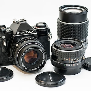 Pentax ME Super- BLACK- 35mm Film Camera with 3 lenses 50 mm f/1.8 28 mm f/2.8 135 mm f/3.5