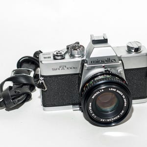 MINOLTA SRT 100b film camera with 50 mm f/2 ROKKOR lens.