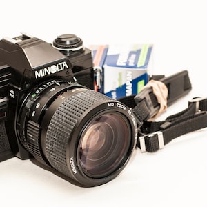 35 mm film camera MINOLTA x300 - BLACK - with 35-70 mm f/3.5 MACRO lens, strap and two b&w film rolls.